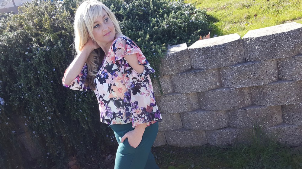 Ruffles, cut-out shoulder and slight bell sleeve